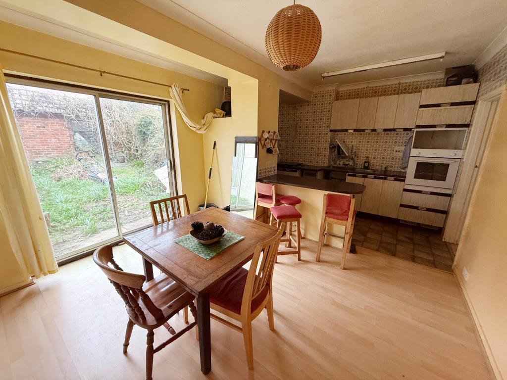 Lot: 111 - ESTABLISHED FOUR-BEDROOM TERRACE HOUSE FOR IMPROVEMENT - Kitchen and Dining Area with patio doors to rear garden